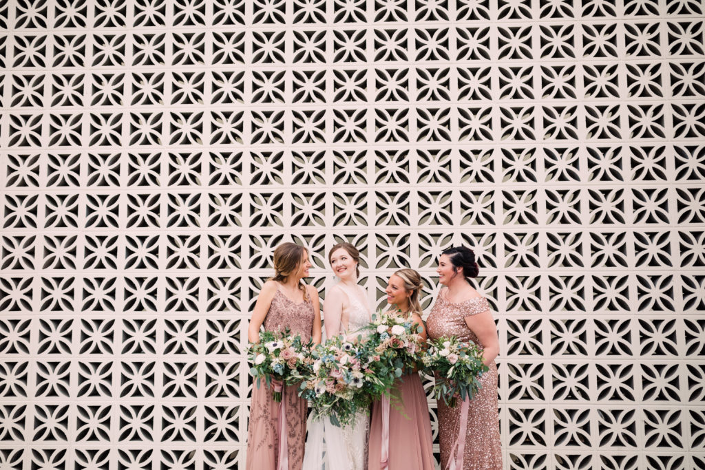 Bride and bridesmaids with luscious bouquets and sequin dresses