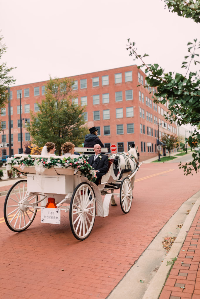 Bride and parents in horse drawn carriage
