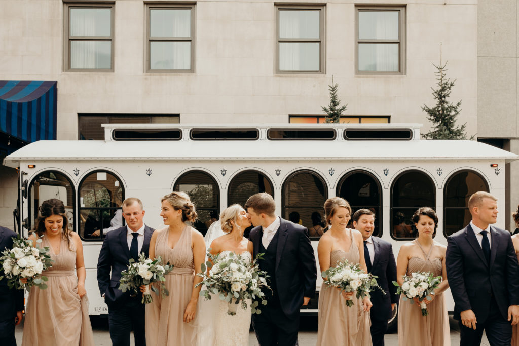 Bridal party in front of white trolly